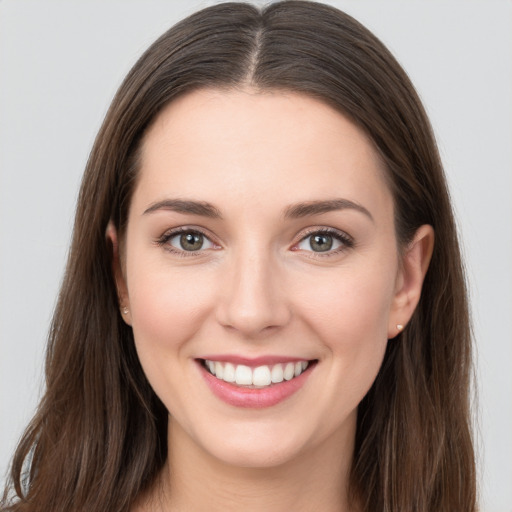 Joyful white young-adult female with long  brown hair and grey eyes