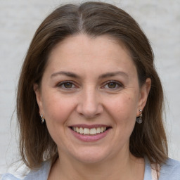 Joyful white adult female with medium  brown hair and grey eyes