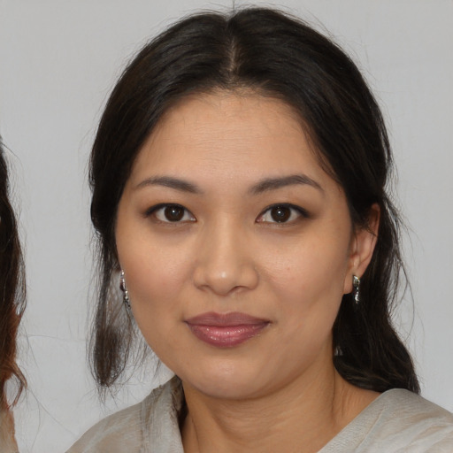Joyful asian young-adult female with medium  brown hair and brown eyes