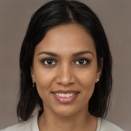 Joyful black young-adult female with medium  brown hair and brown eyes