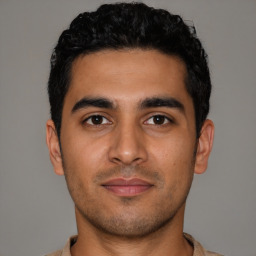 Joyful latino young-adult male with short  black hair and brown eyes