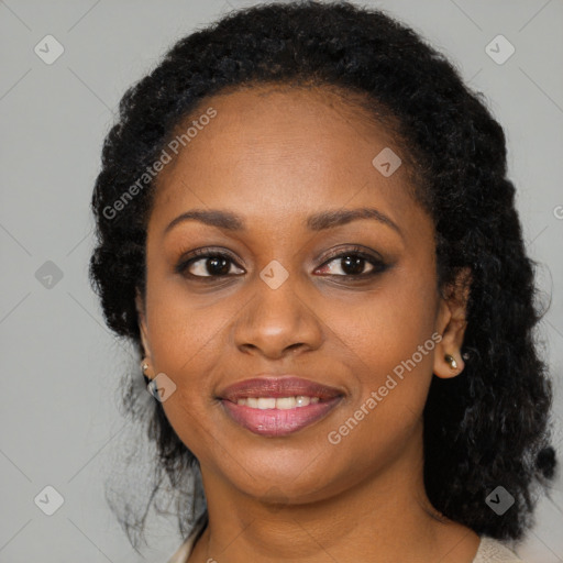 Joyful black young-adult female with long  black hair and brown eyes