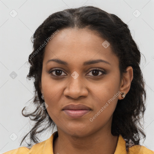 Joyful black young-adult female with long  brown hair and brown eyes