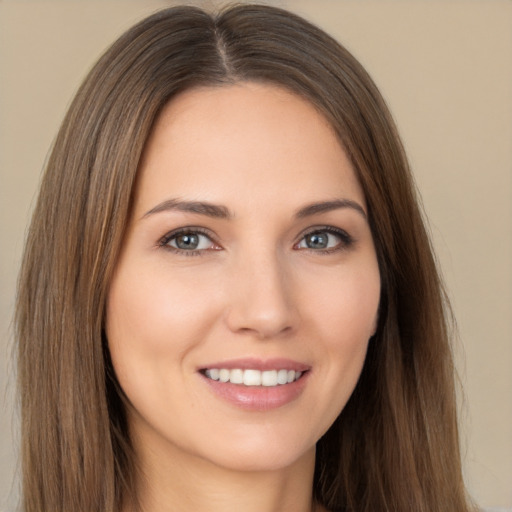 Joyful white young-adult female with long  brown hair and brown eyes