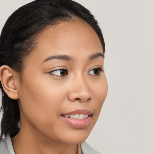 Joyful latino young-adult female with long  brown hair and brown eyes