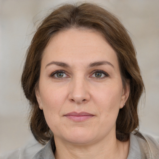 Joyful white adult female with medium  brown hair and brown eyes