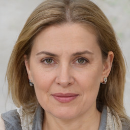 Joyful white adult female with medium  brown hair and grey eyes