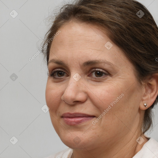 Joyful white adult female with medium  brown hair and brown eyes