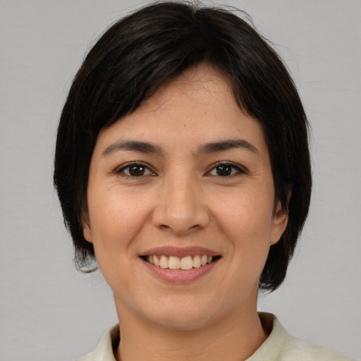 Joyful asian young-adult female with medium  brown hair and brown eyes