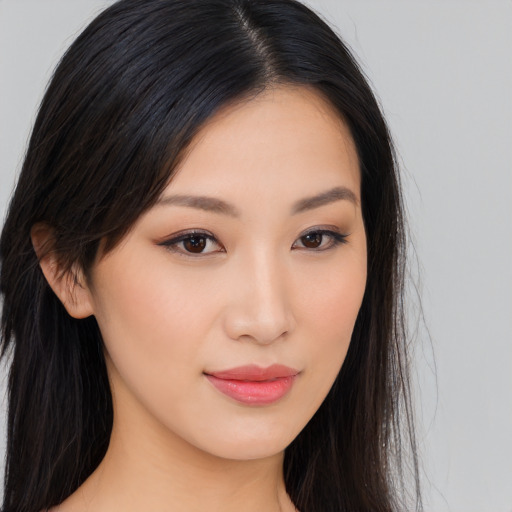 Joyful asian young-adult female with long  brown hair and brown eyes