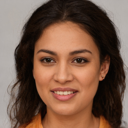 Joyful white young-adult female with long  brown hair and brown eyes