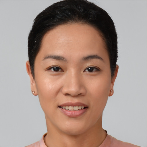 Joyful asian young-adult female with short  black hair and brown eyes