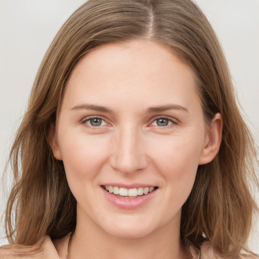 Joyful white young-adult female with medium  brown hair and grey eyes