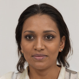 Joyful black young-adult female with medium  brown hair and brown eyes