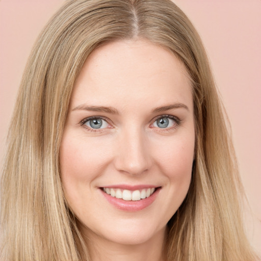 Joyful white young-adult female with long  brown hair and green eyes