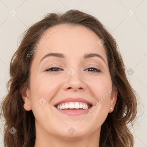 Joyful white young-adult female with long  brown hair and blue eyes