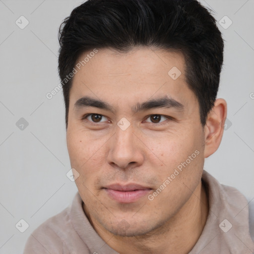 Joyful asian young-adult male with short  brown hair and brown eyes