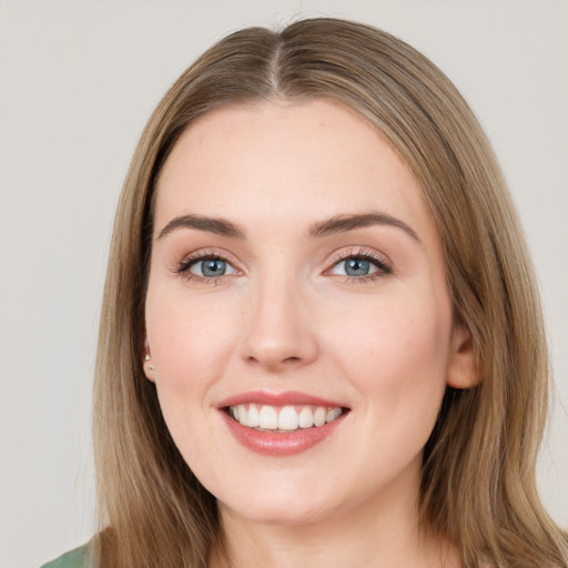 Joyful white young-adult female with long  brown hair and green eyes