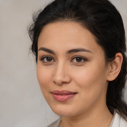 Joyful latino young-adult female with medium  brown hair and brown eyes