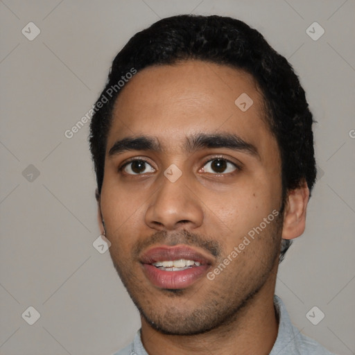 Joyful latino young-adult male with short  black hair and brown eyes