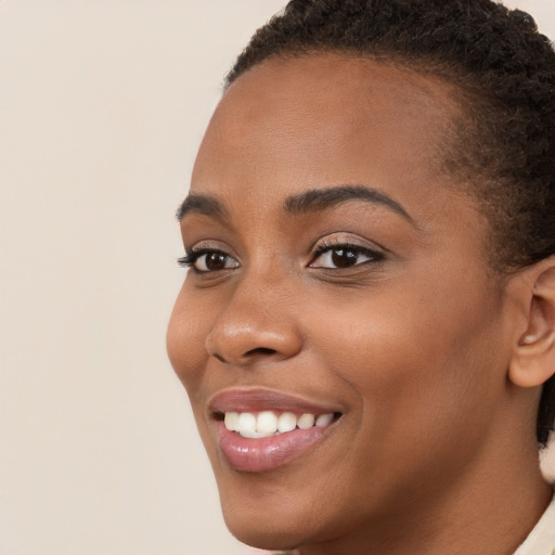 Joyful latino young-adult female with short  brown hair and brown eyes