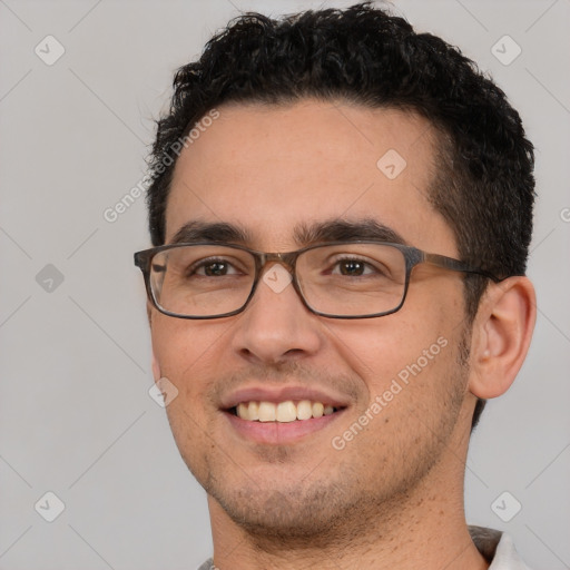 Joyful white young-adult male with short  black hair and brown eyes