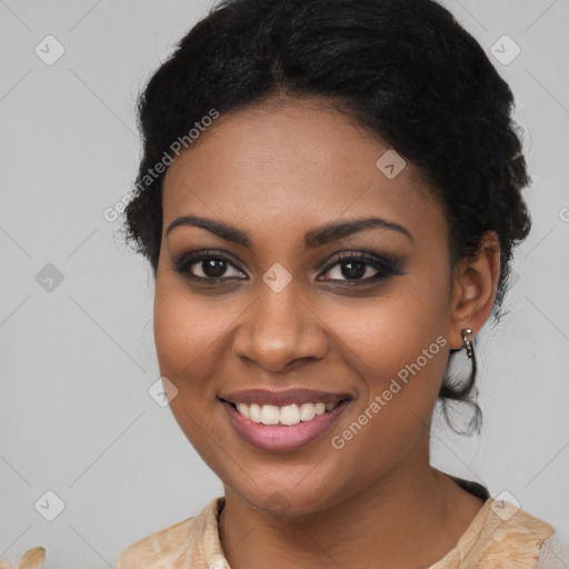 Joyful black young-adult female with long  black hair and brown eyes