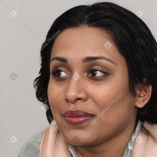 Joyful latino young-adult female with medium  black hair and brown eyes