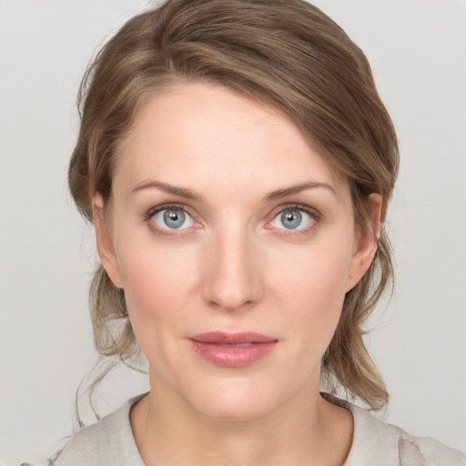 Joyful white young-adult female with medium  brown hair and grey eyes