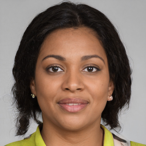 Joyful black young-adult female with medium  brown hair and brown eyes