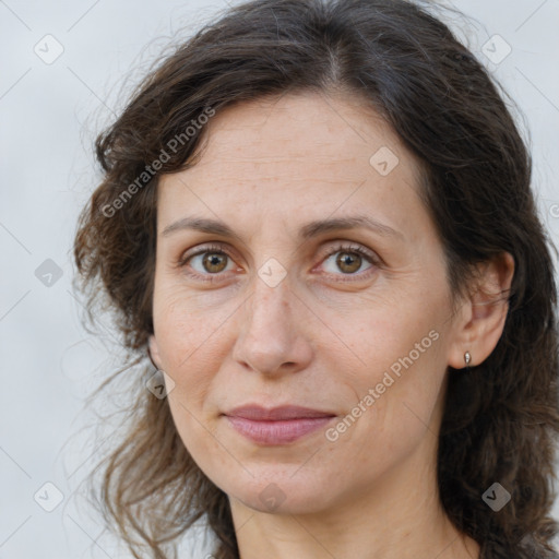 Joyful white adult female with long  brown hair and brown eyes