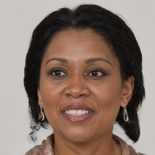 Joyful black adult female with medium  brown hair and brown eyes