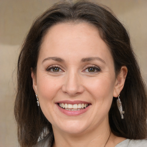 Joyful white adult female with medium  brown hair and brown eyes