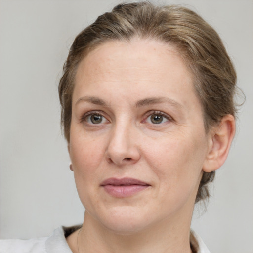 Joyful white adult female with short  brown hair and grey eyes