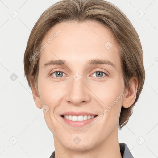 Joyful white young-adult female with short  brown hair and grey eyes