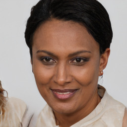 Joyful black adult female with short  brown hair and brown eyes