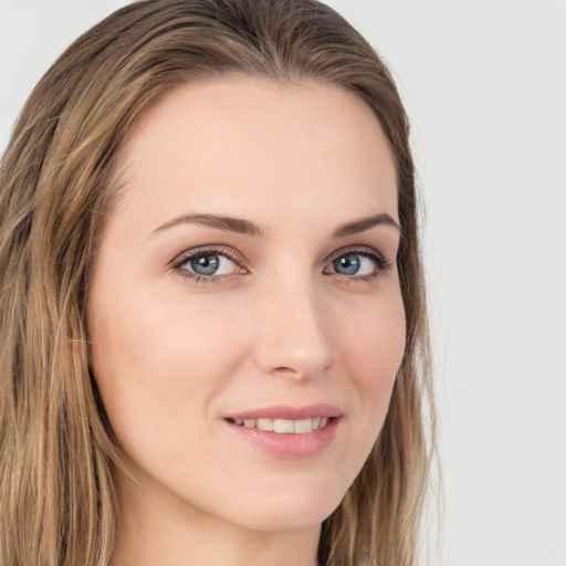 Joyful white young-adult female with long  brown hair and green eyes