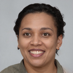 Joyful black adult female with short  brown hair and brown eyes