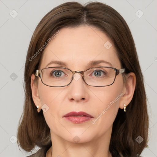 Joyful white adult female with medium  brown hair and grey eyes