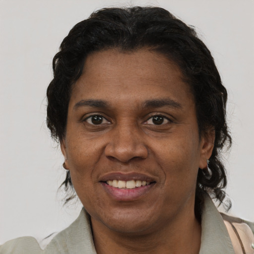 Joyful black adult female with short  brown hair and brown eyes