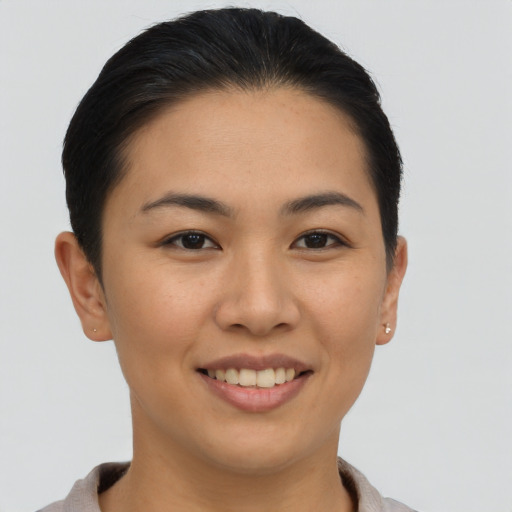 Joyful asian young-adult female with short  brown hair and brown eyes