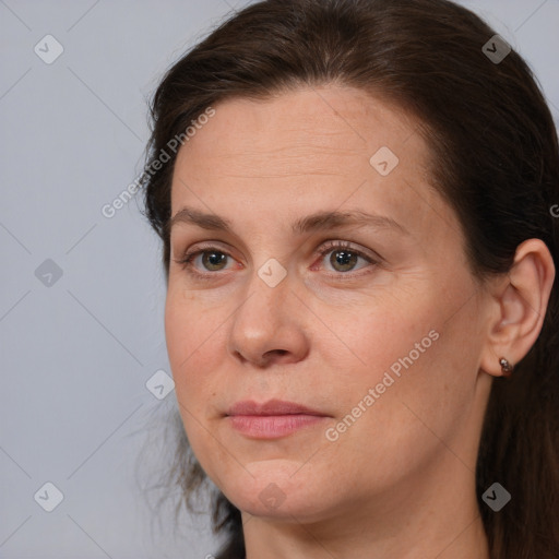 Joyful white adult female with long  brown hair and brown eyes