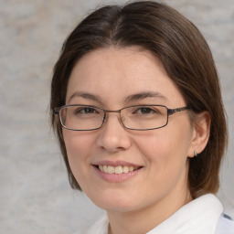 Joyful white adult female with medium  brown hair and brown eyes