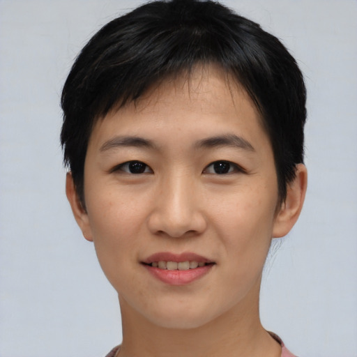 Joyful asian young-adult female with short  black hair and brown eyes