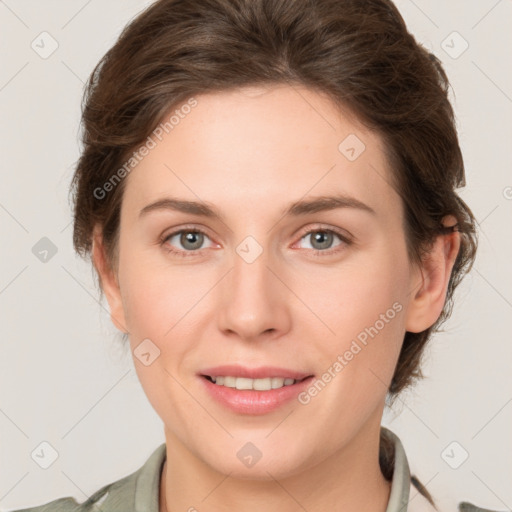 Joyful white young-adult female with medium  brown hair and grey eyes