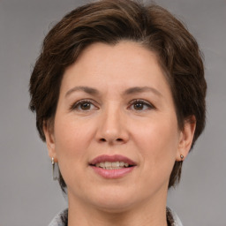 Joyful white adult female with short  brown hair and brown eyes