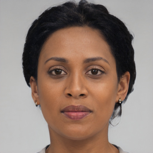 Joyful black young-adult female with medium  black hair and brown eyes