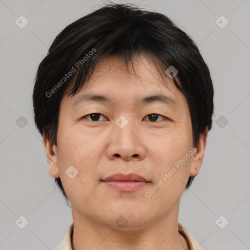 Joyful asian adult male with short  brown hair and brown eyes