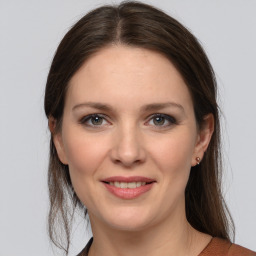 Joyful white young-adult female with medium  brown hair and grey eyes