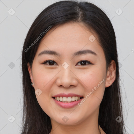 Joyful asian young-adult female with long  brown hair and brown eyes